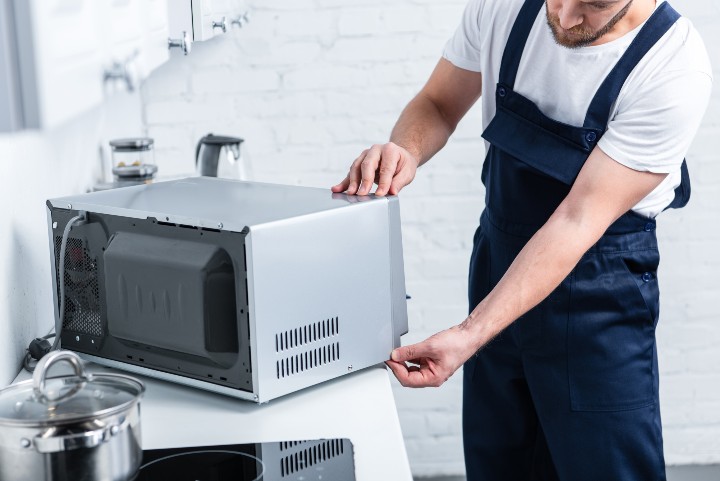 Man repairing microwave